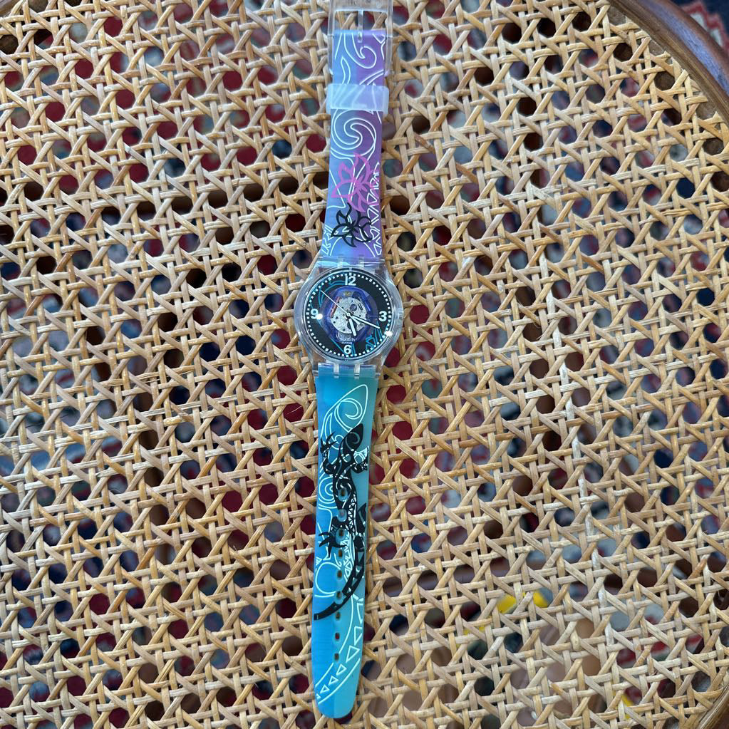 Colorful watch with a character face on a wicker surface