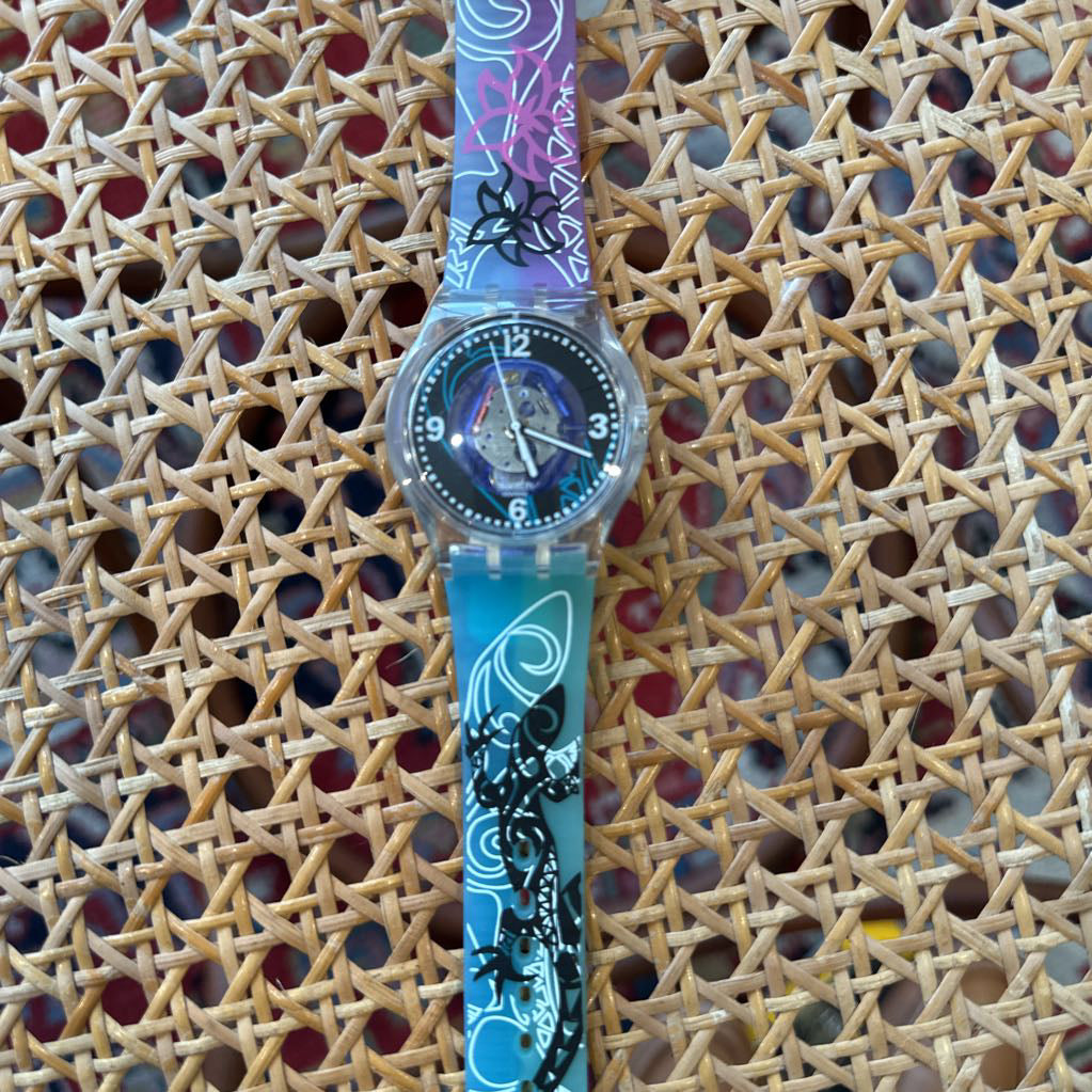 Colorful watch with a decorative strap on a textured surface