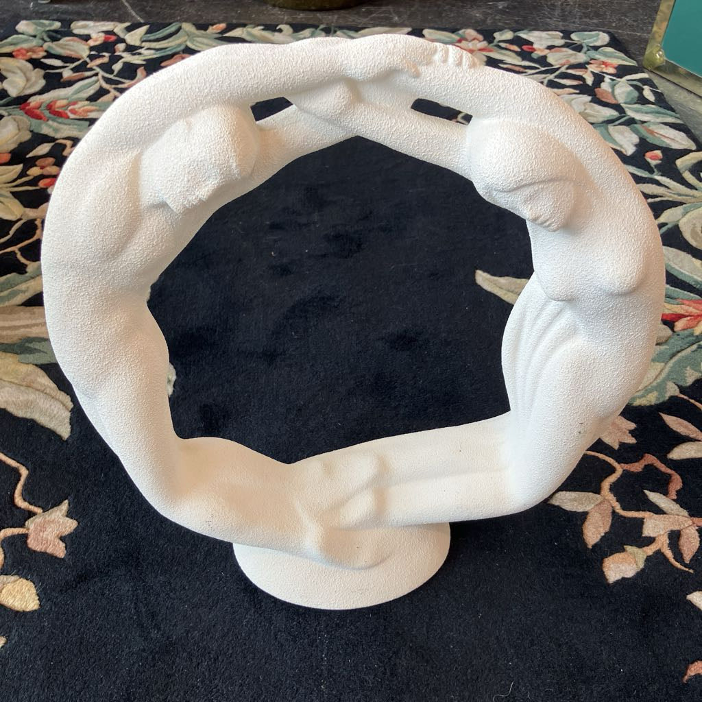 White sculpture on a floral-patterned surface