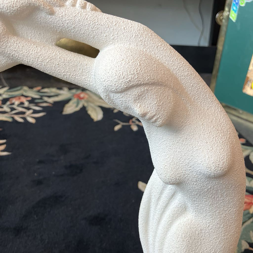 Close-up of a textured white sculpture with a blurred background