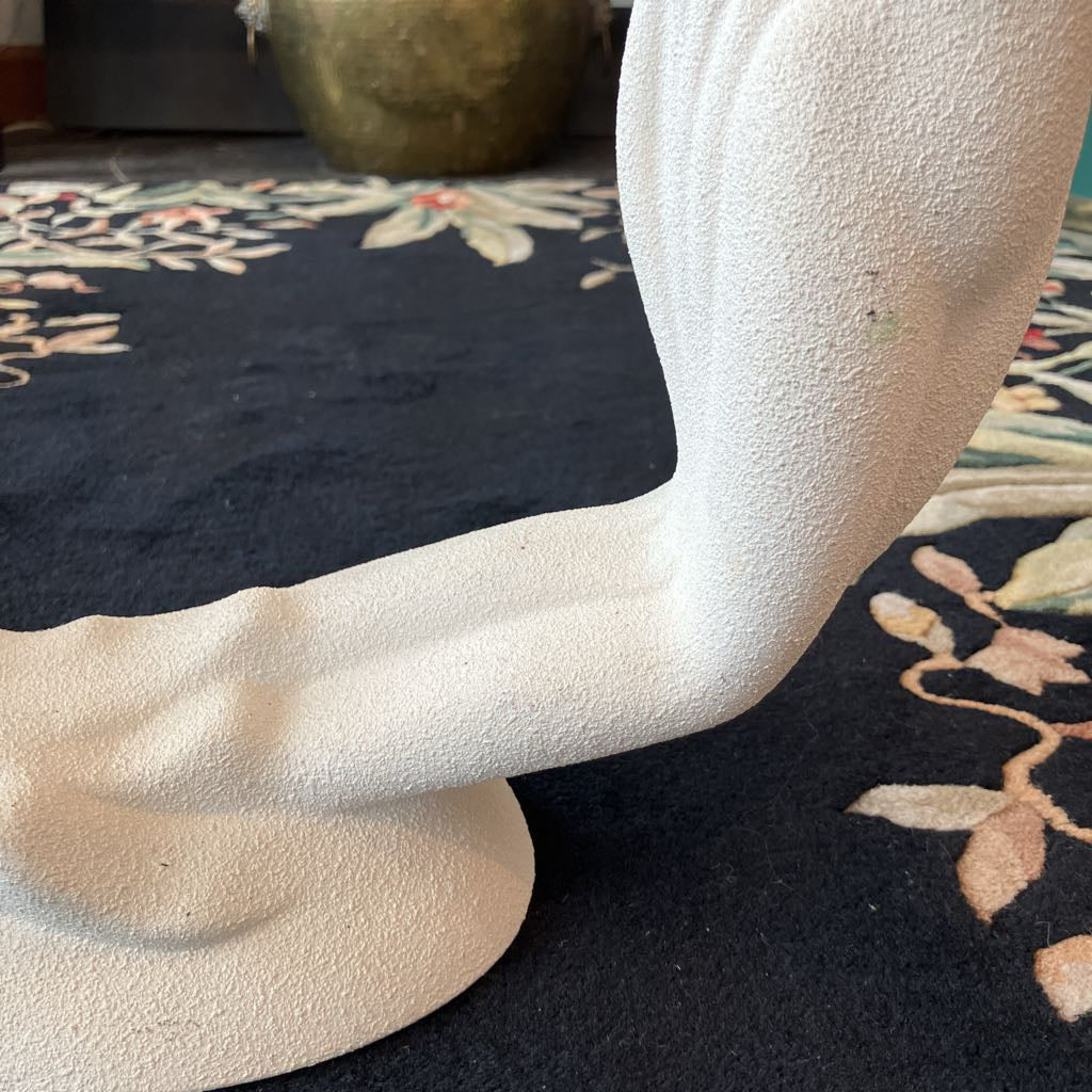 Close-up of a textured white sculpture with a blurred background