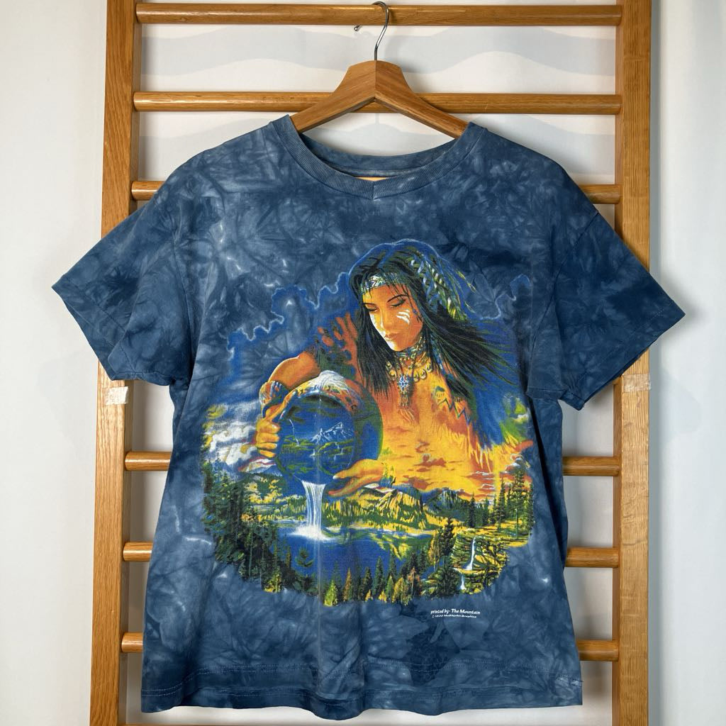 Tie-dye t-shirt with a graphic design of a person holding water, hanging on a wooden rack.