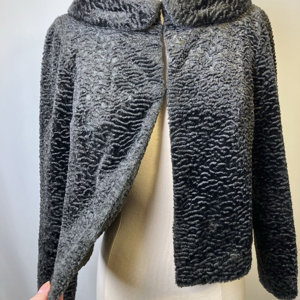 Textured gray sweater on a mannequin against a plain background