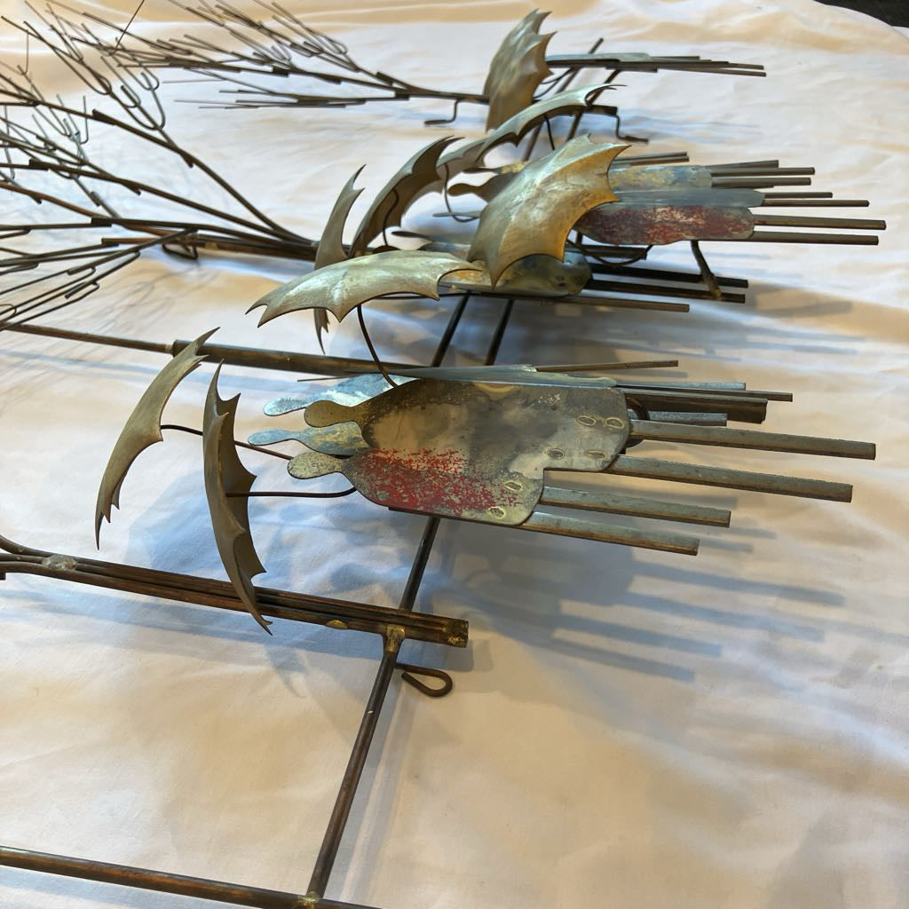 Metal wall art with abstract design on a textured surface