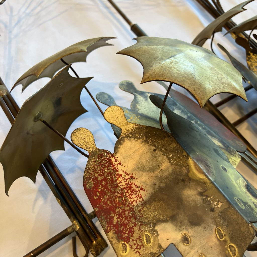 Decorative wall art with abstract figures and umbrellas