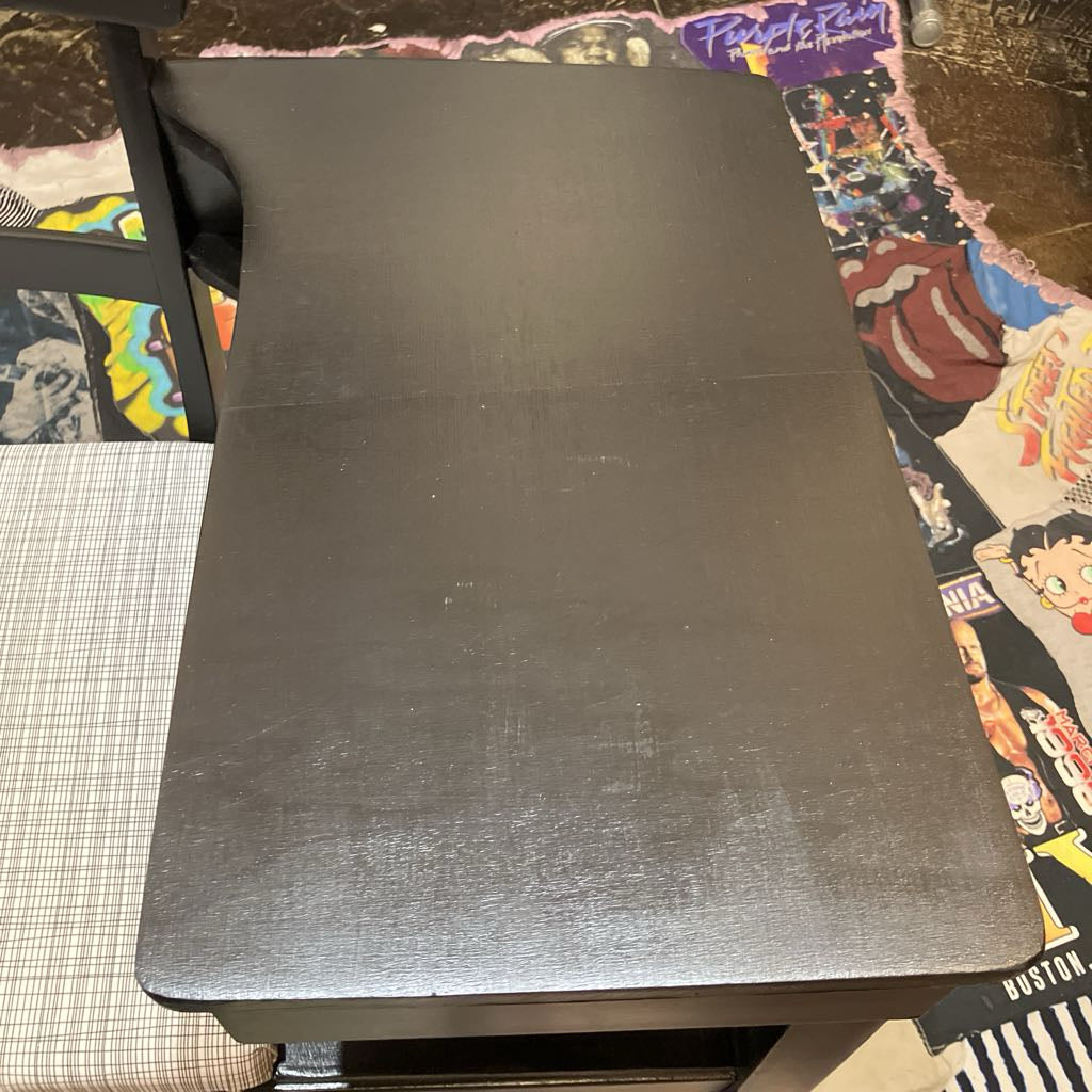 Black rectangular desk on a colorful surface 