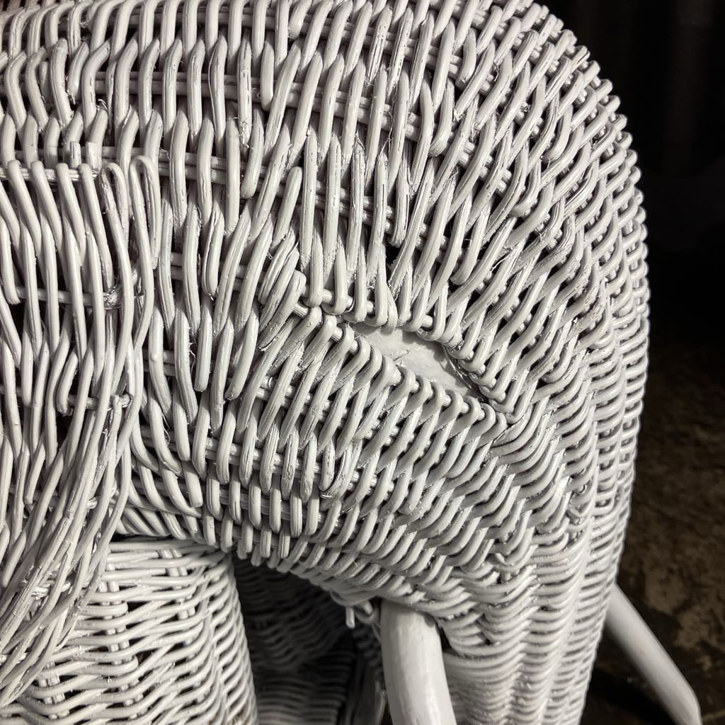 Close-up of a wicker elephant face with intricate patterns.