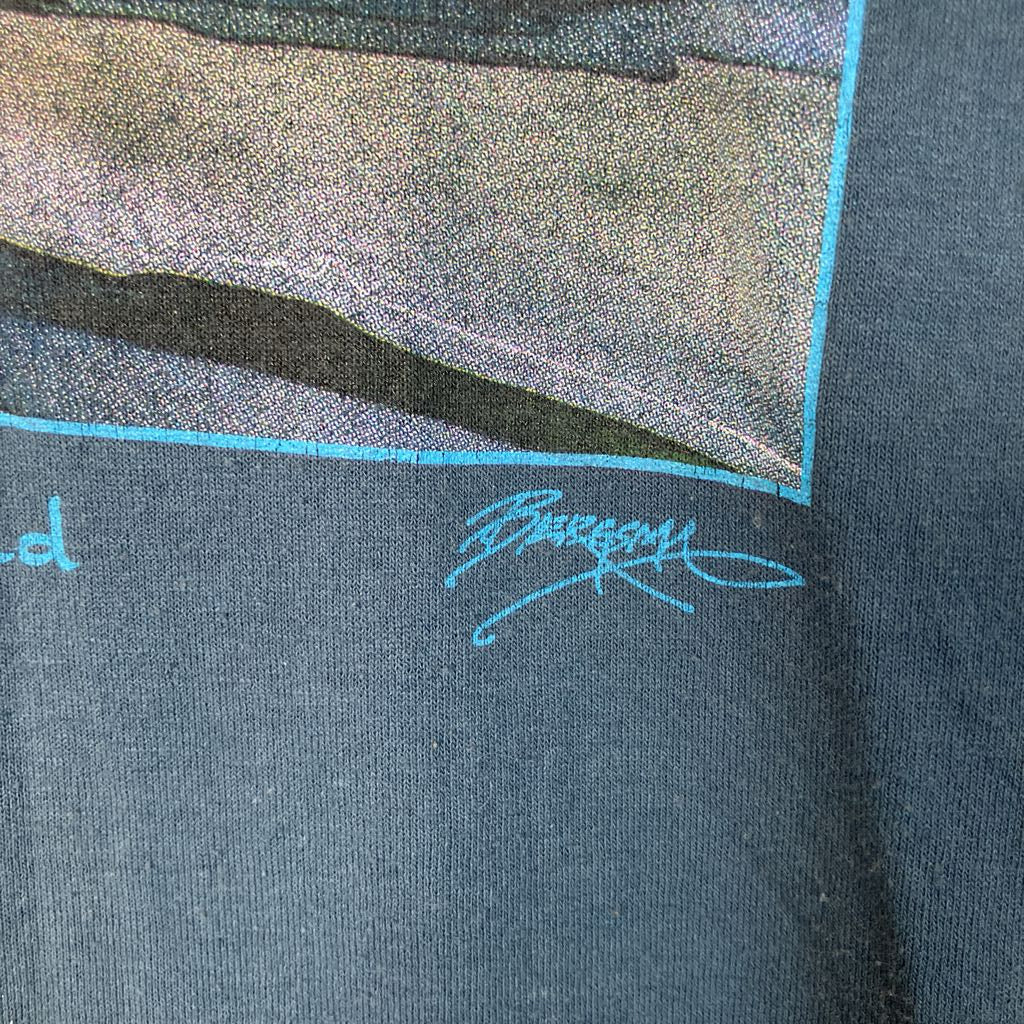 Close-up of a dark gray fabric with a brand logo on a textured background