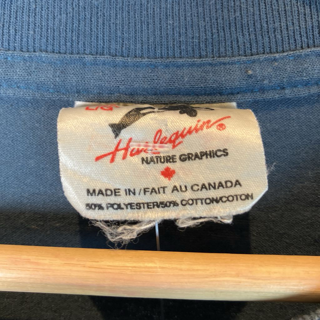 Close-up of a label on a blue denim jacket with 'Hurlequin' branding.