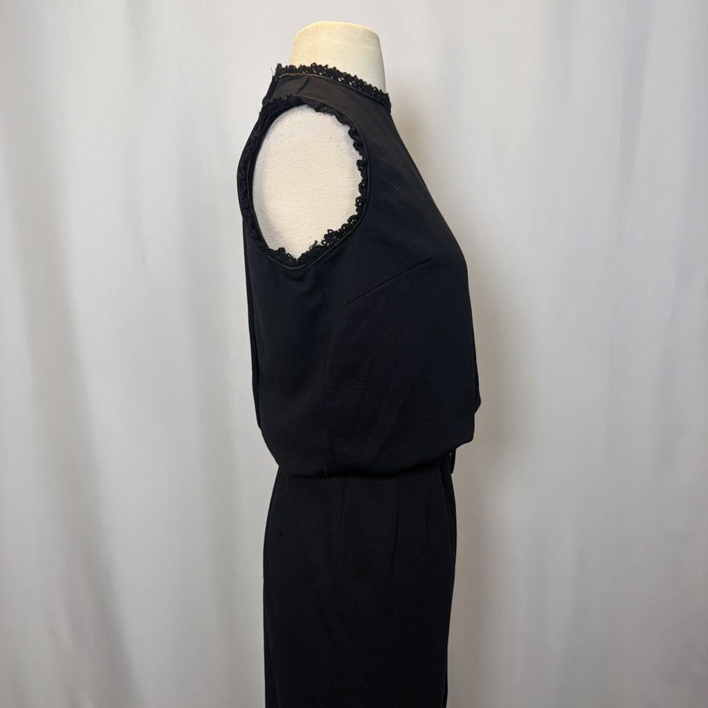 Black sleeveless top with lace details on a mannequin against a plain background