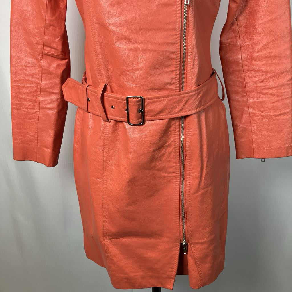 close up of orange belt details on jacket on mannequin