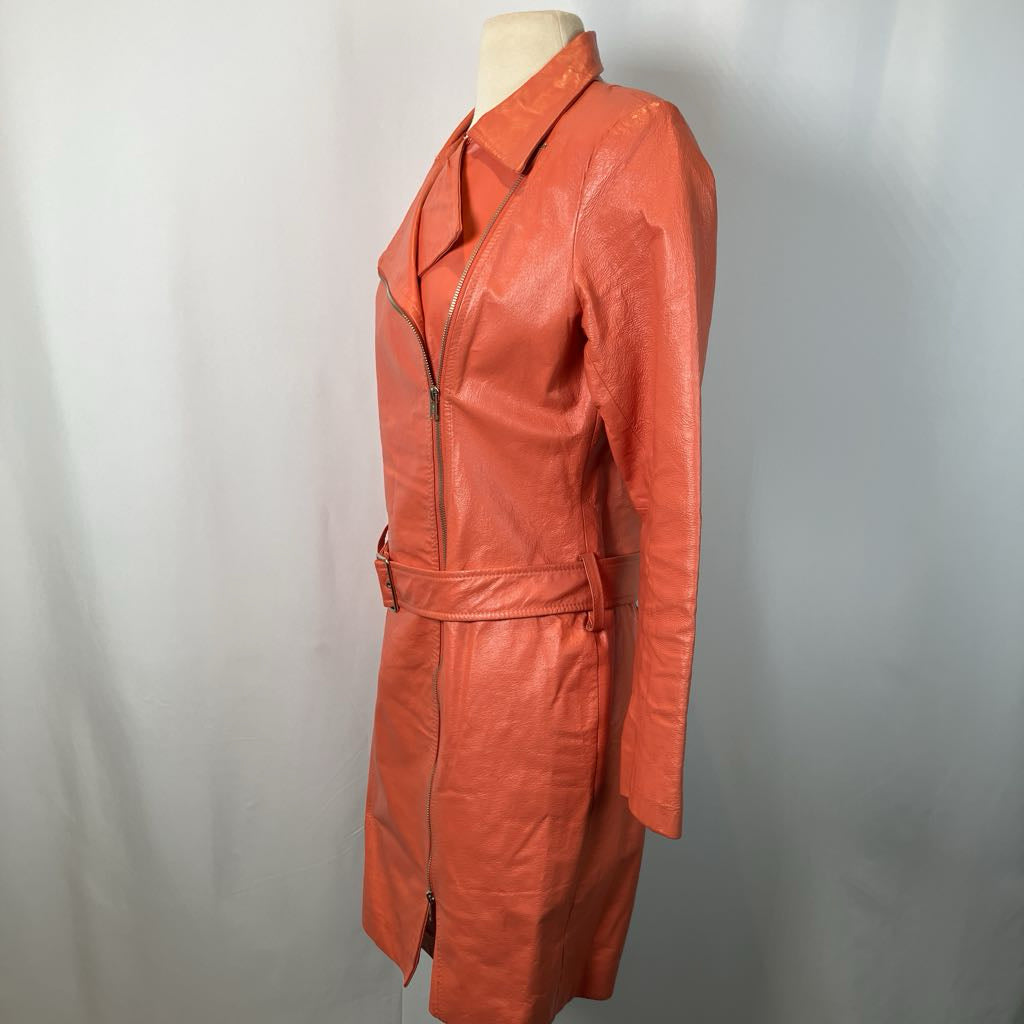 Orange leather trench coat on a mannequin against a plain background