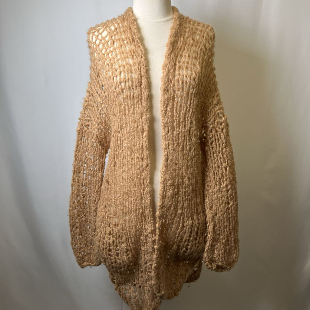 Beige knitted cardigan on a mannequin against a plain background