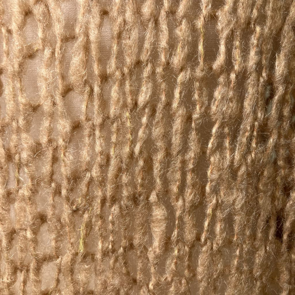 Close-up of textured beige fabric with a woven pattern