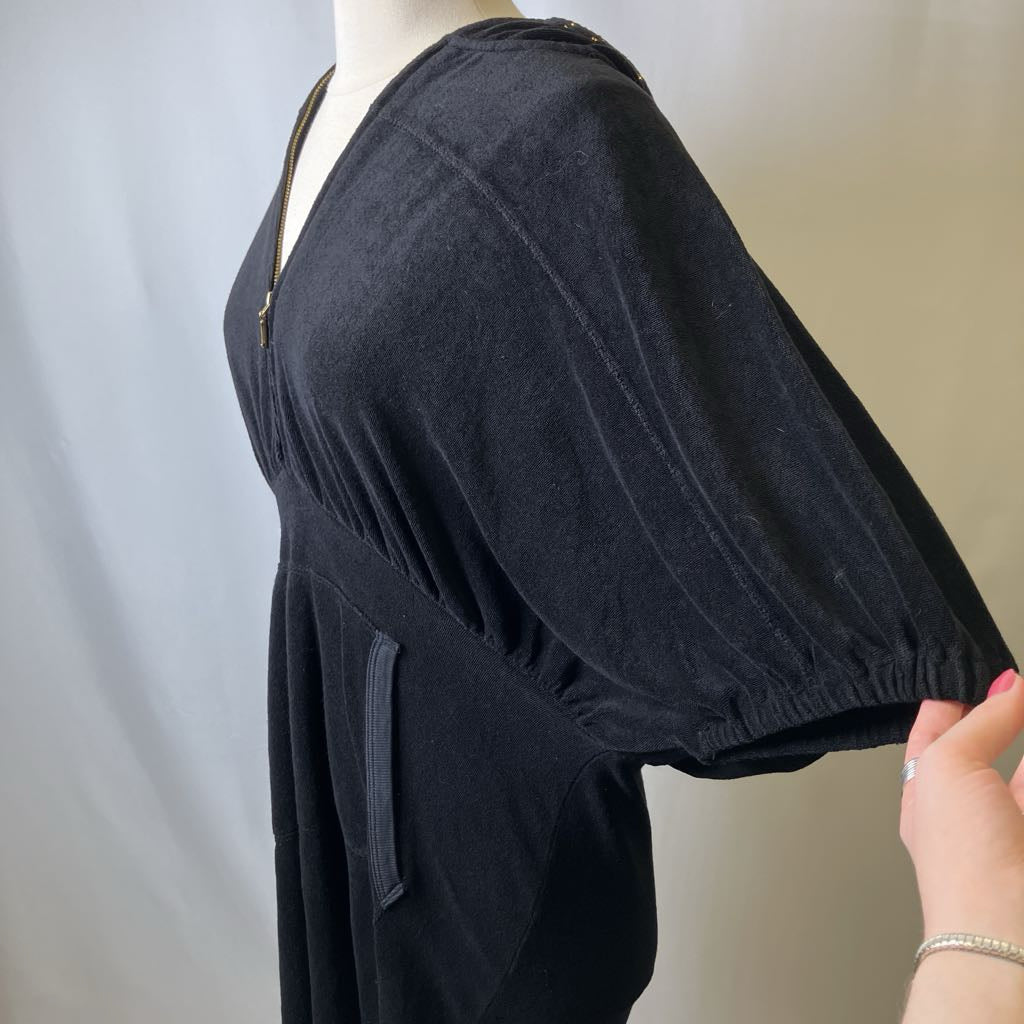 Black dress on a mannequin with a blurred background