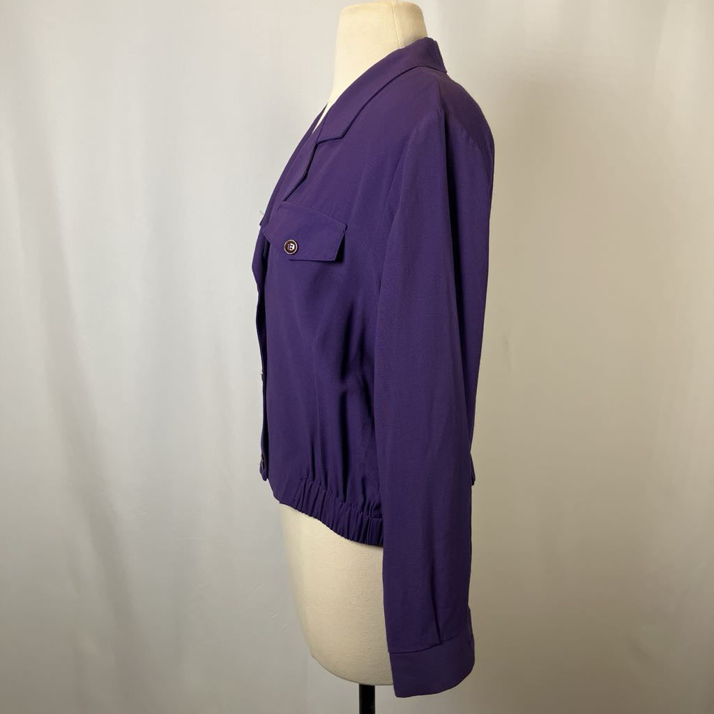 Purple jacket on a mannequin against a plain background