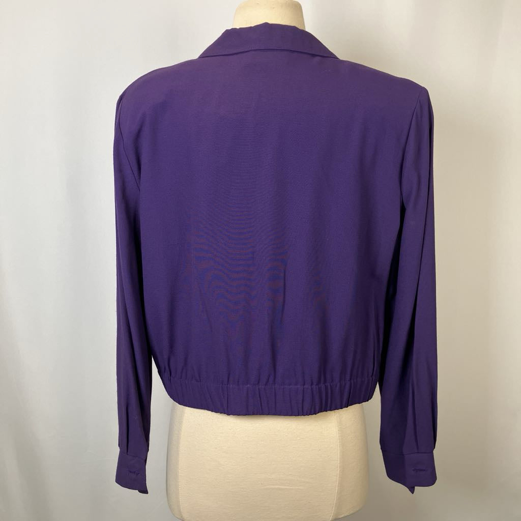 Purple jacket on a mannequin against a plain background