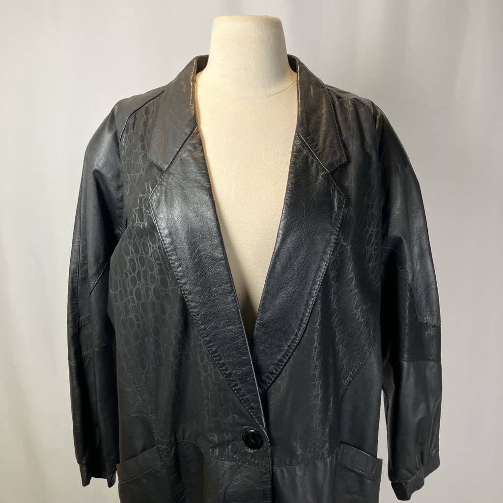 Black leather jacket on a mannequin against a plain background