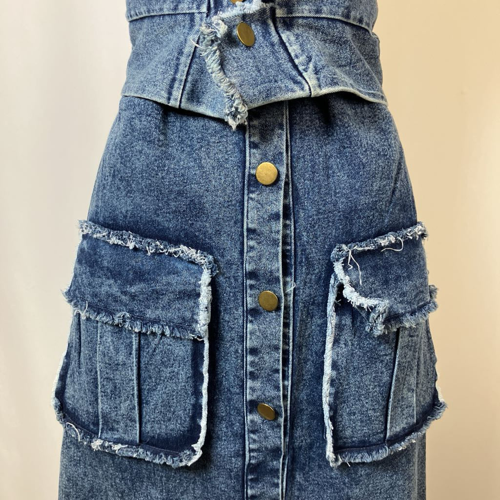 Denim jacket with frayed edges and button details on a beige background