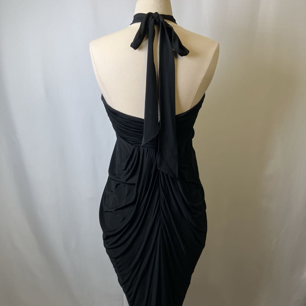 Black halter neck dress on a mannequin against a plain background