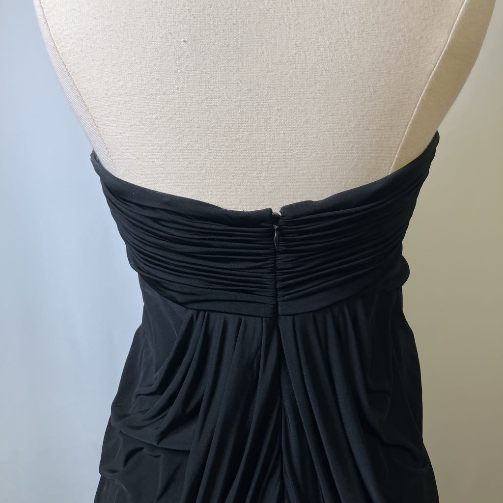 Black strapless dress on a mannequin against a neutral background