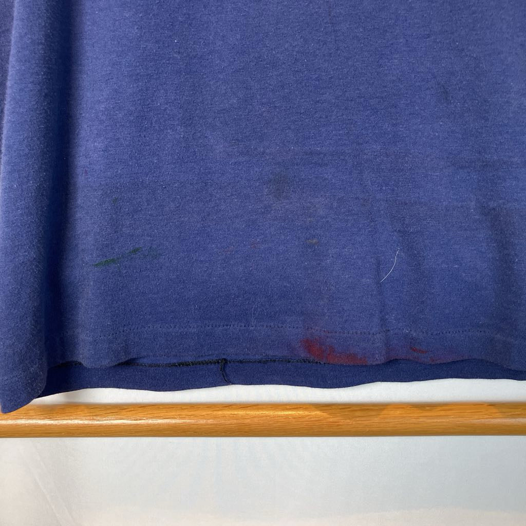 Blue fabric with stains on a white surface with a wooden edge