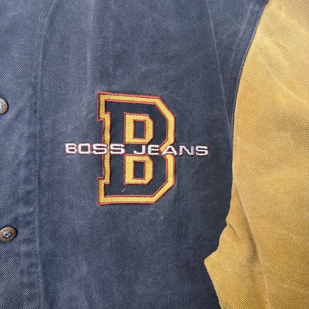 Black and tan jacket with 'BOSS JEANS' logo on a blue background
