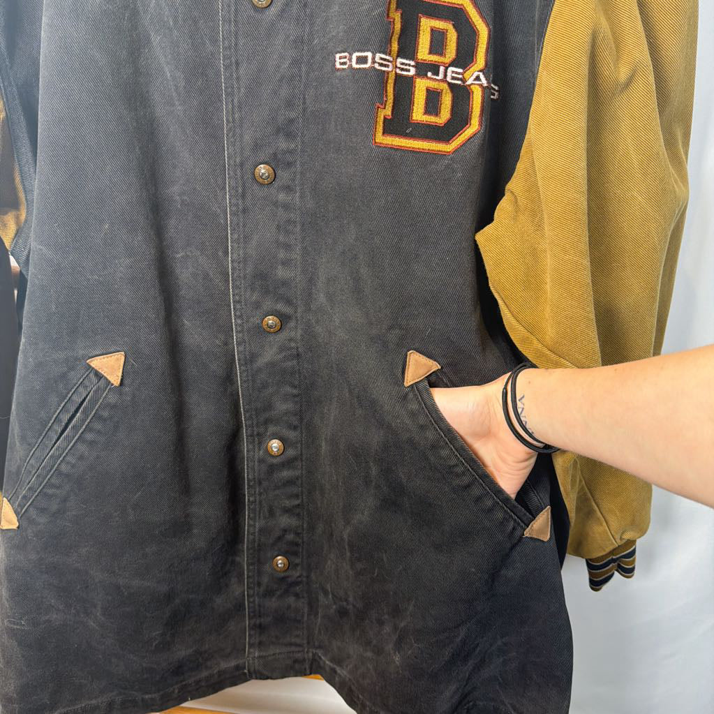 Black and yellow jacket with 'BOSS JEANS' branding on a white background