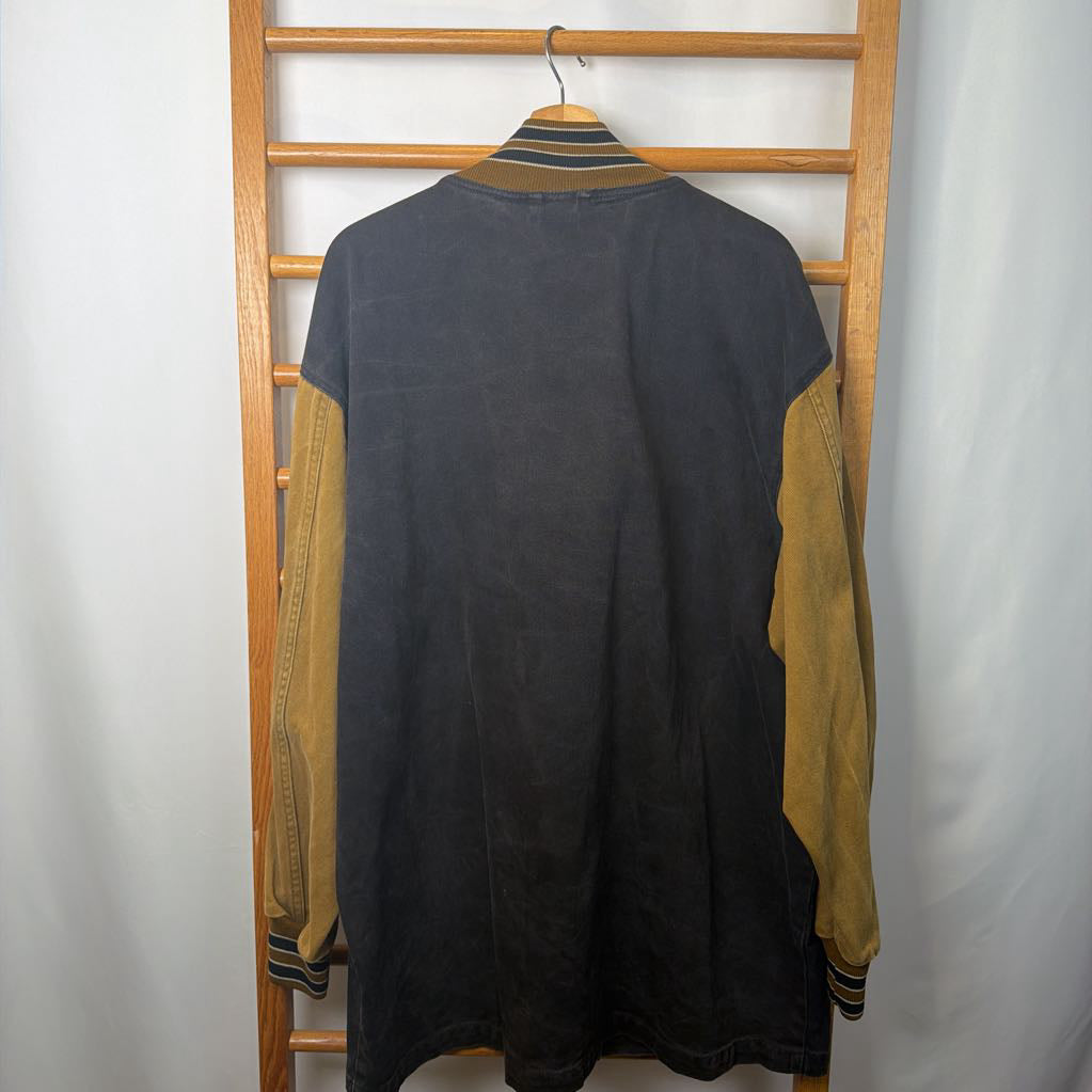 Dark jacket shirt with tan sleeves on a wooden hanger against a white background