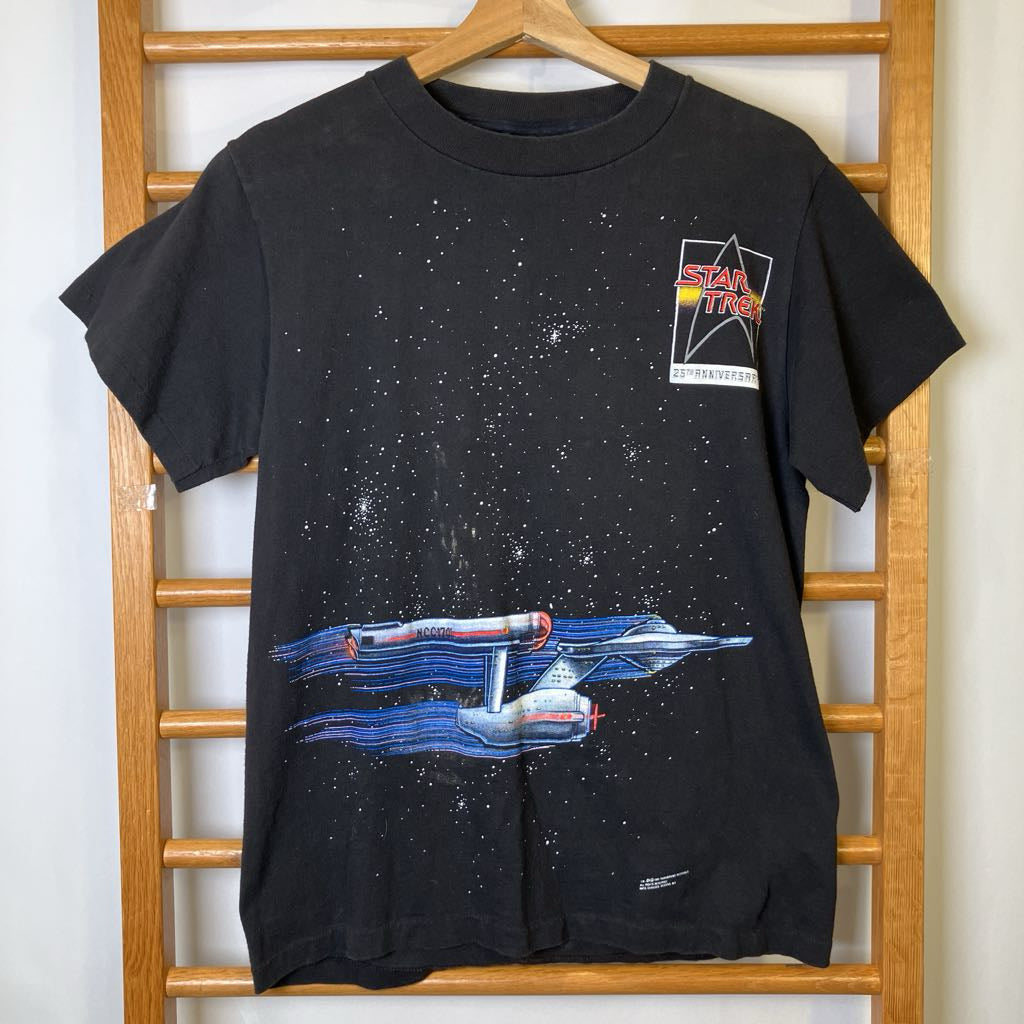 Black t-shirt with Star Trek ship design on a wooden rack