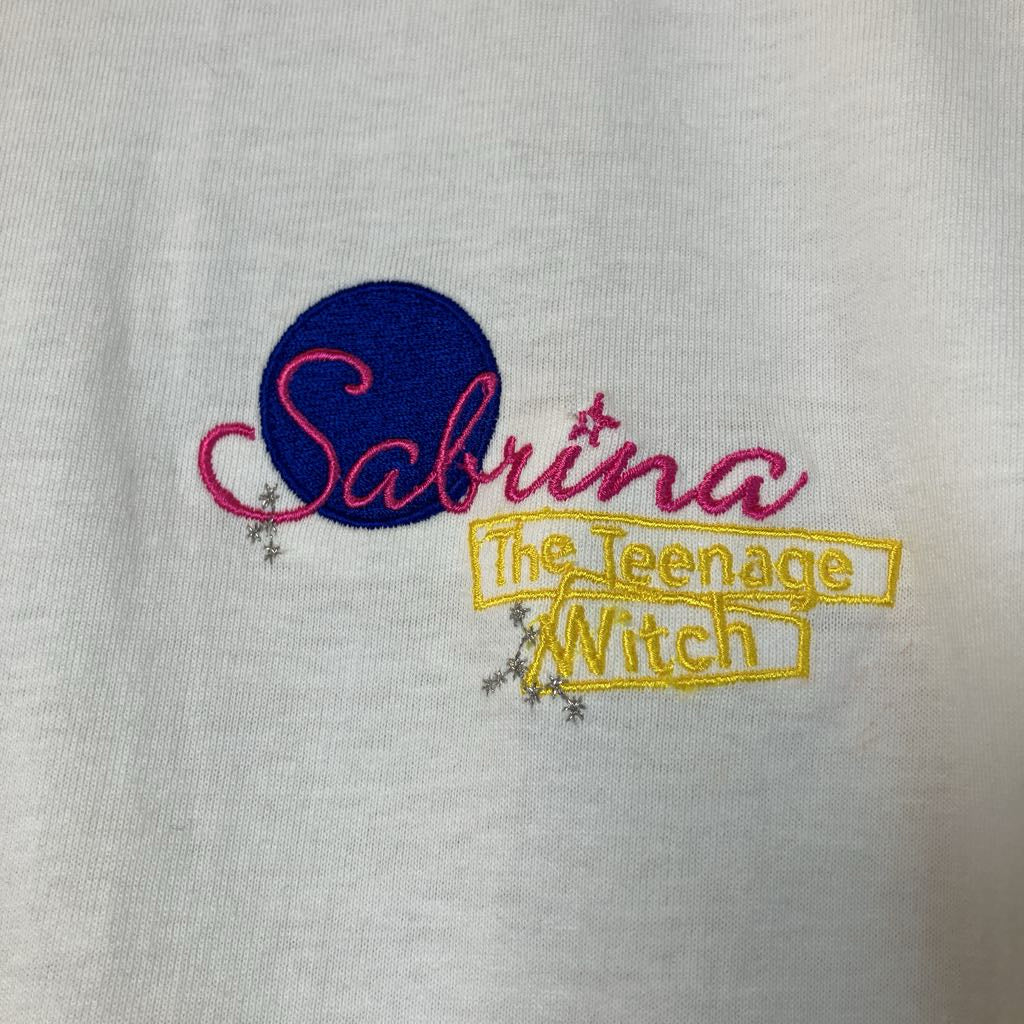 Embroidered text 'Sabrina The Teenage Witch' on a white background
