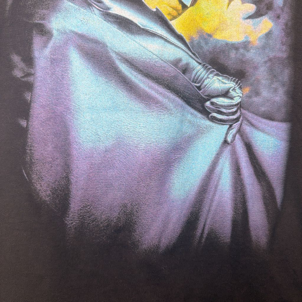 Close-up of a character with a cape and yellow object, likely from a superhero-themed product.