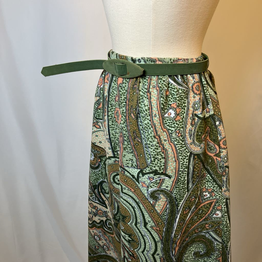Patterned green skirt on a mannequin with a plain background