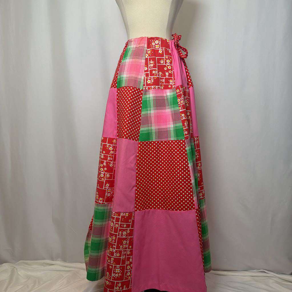 Colorful patchwork skirt on a mannequin against a plain background