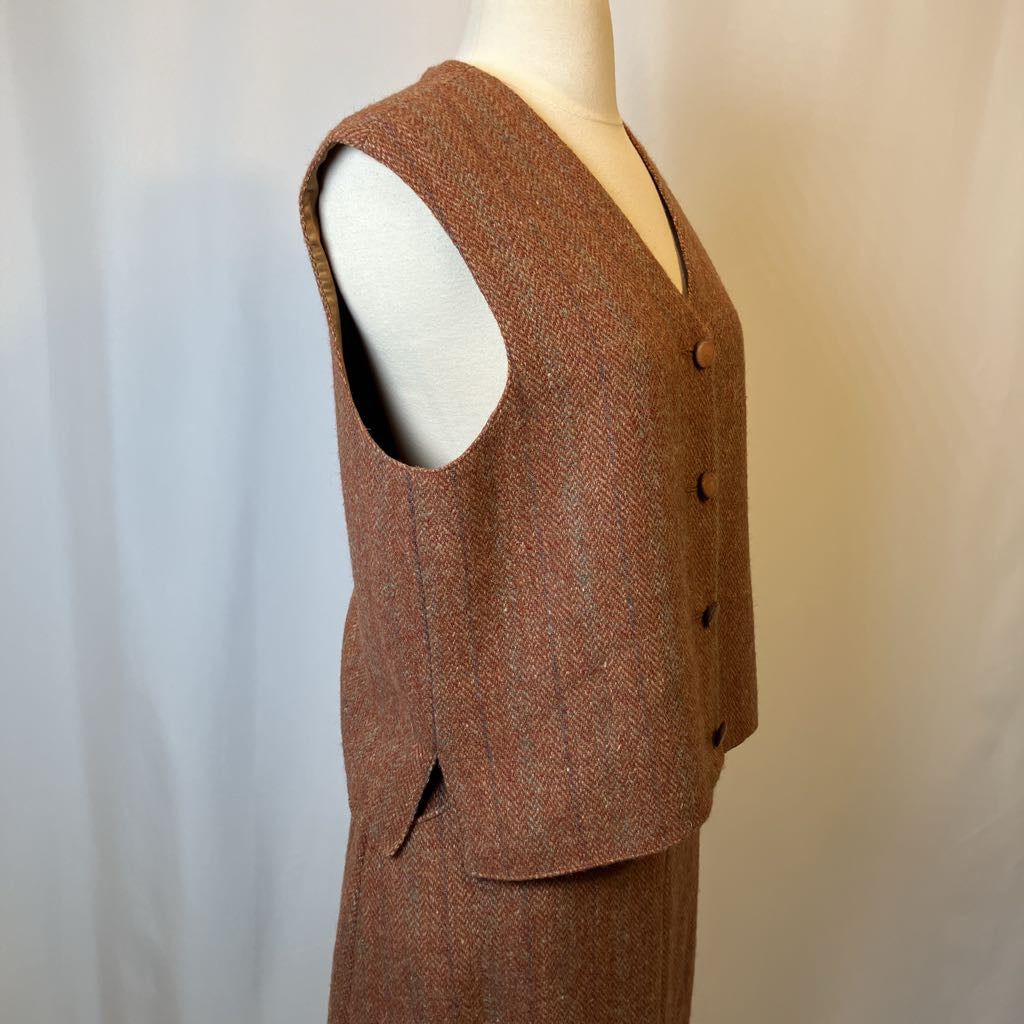 Brown tweed suit on a mannequin against a plain background