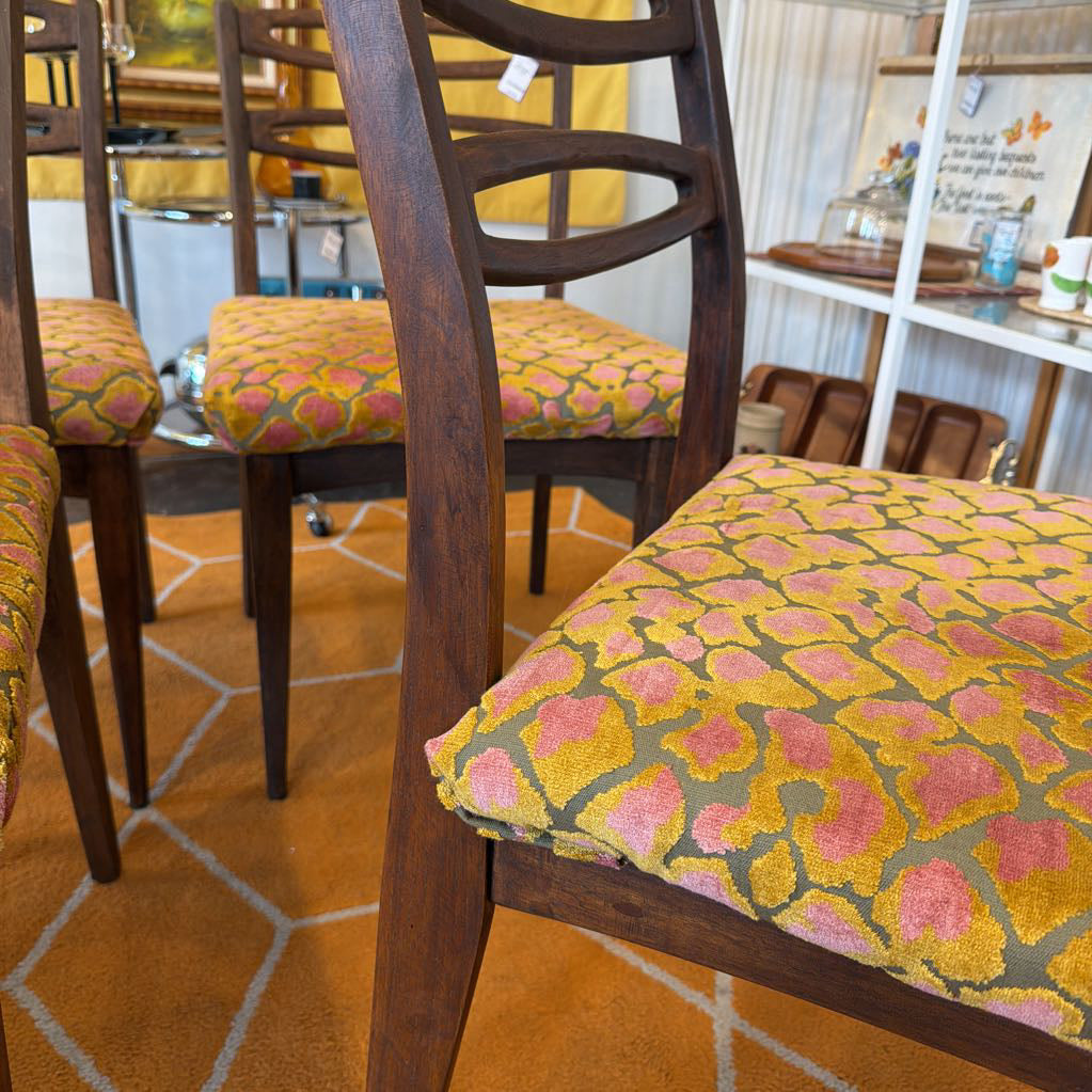 Dining chairs with patterned cushions on a tiled floor