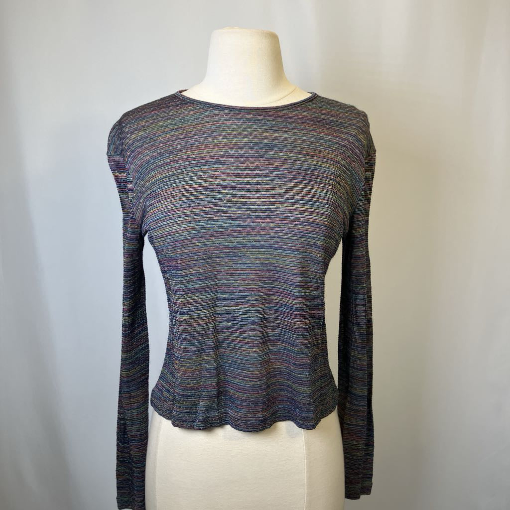 Multicolored long-sleeve knit top on a mannequin against a plain background