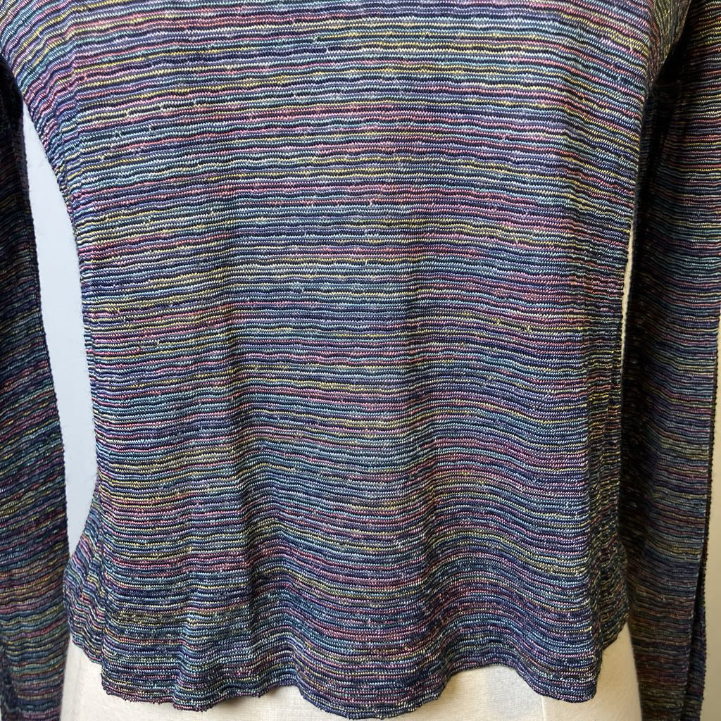 Multicolored knitted sweater on a mannequin against a white background