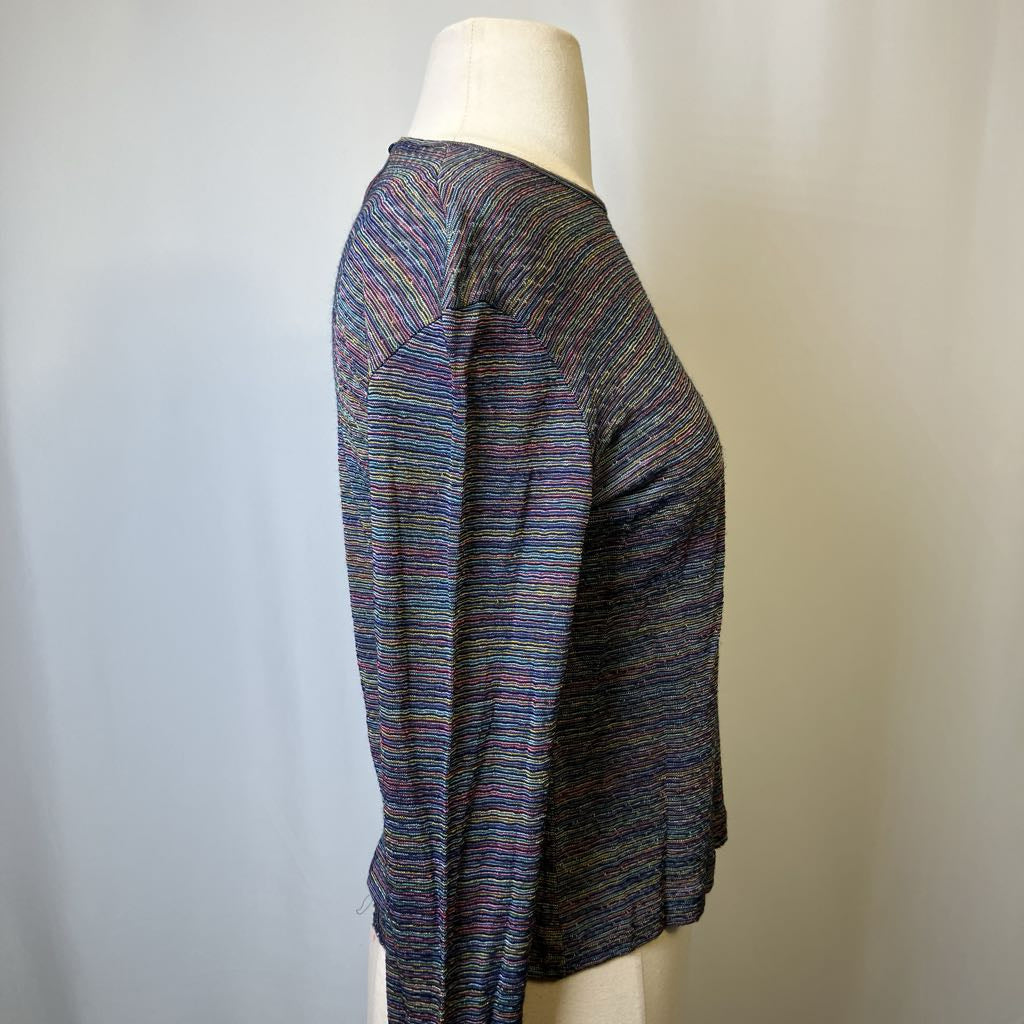 Multicolored sweater on a mannequin against a plain background