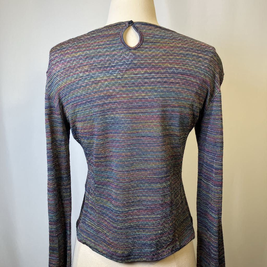 Multicolored long-sleeve top on a mannequin against a neutral background