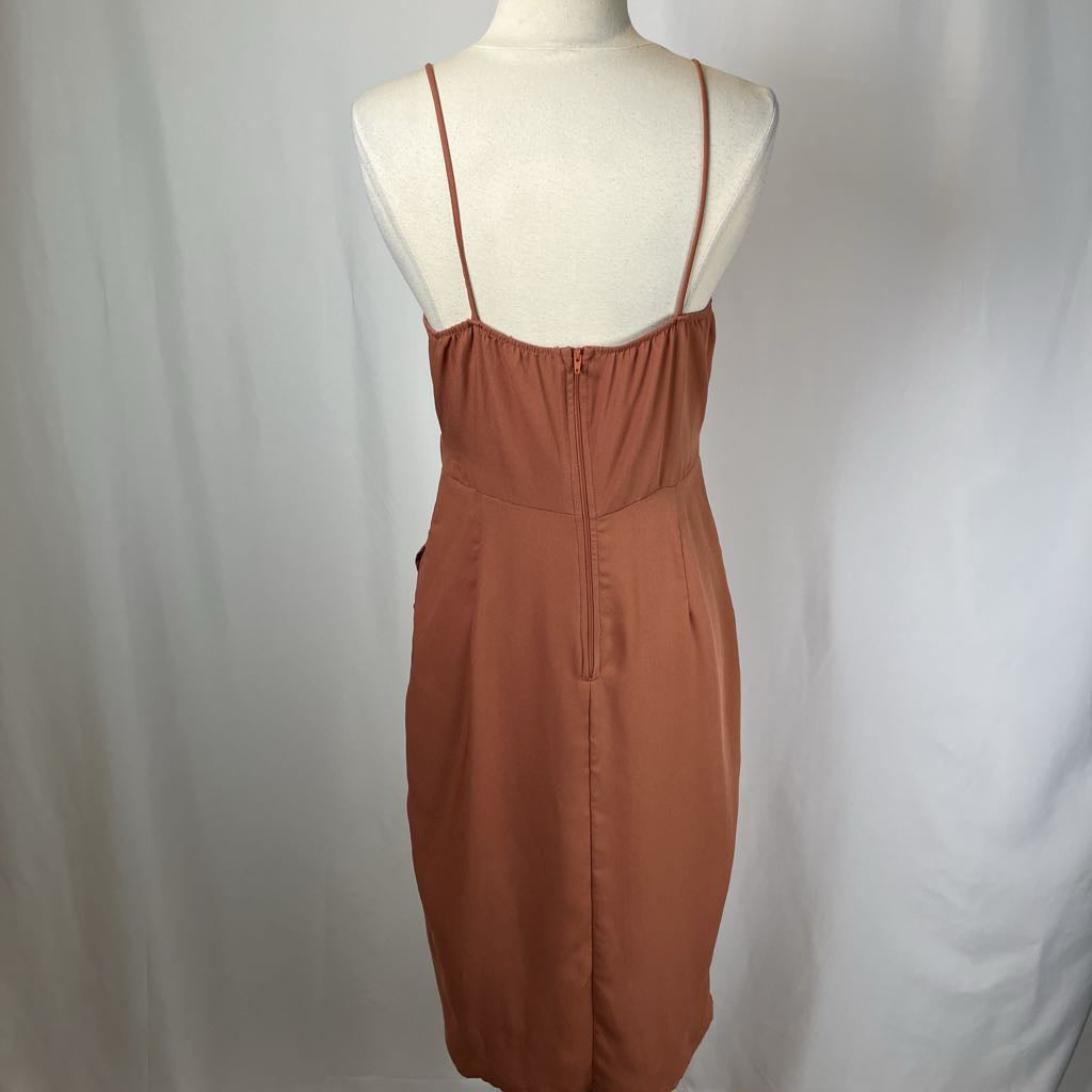 Brown dress on a mannequin against a plain background