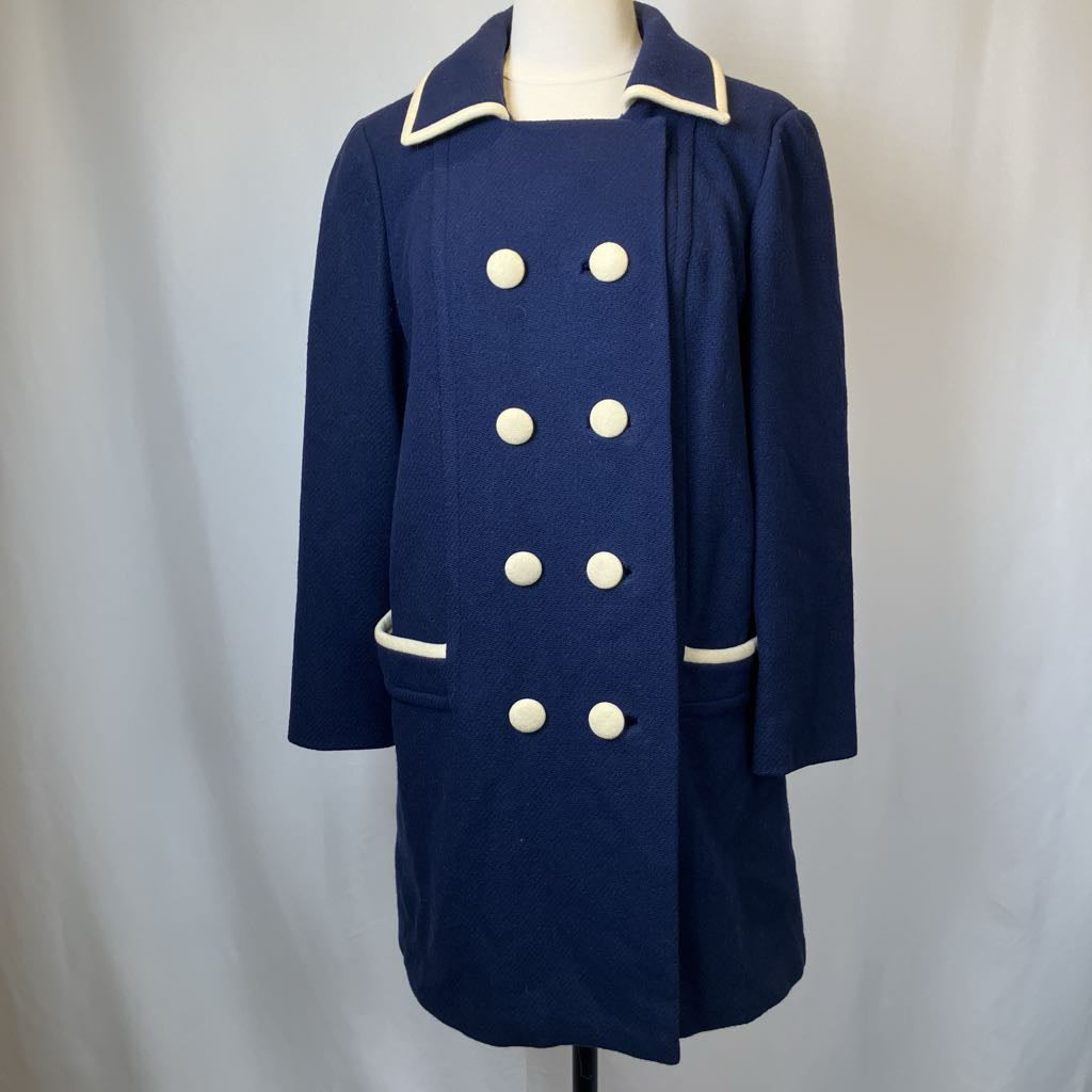 Navy blue coat with white buttons on a mannequin against a plain background