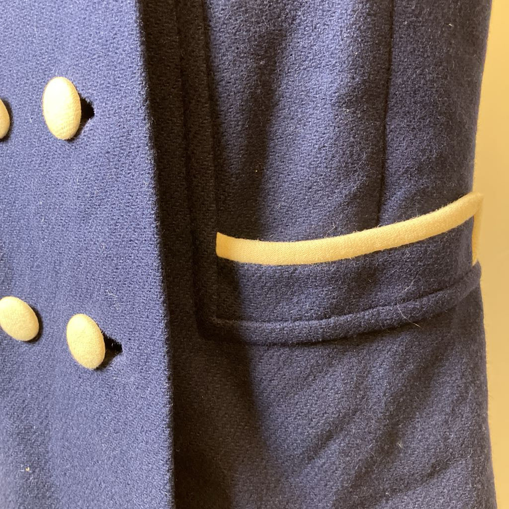 Close-up of a military-style coat with gold buttons and trim.