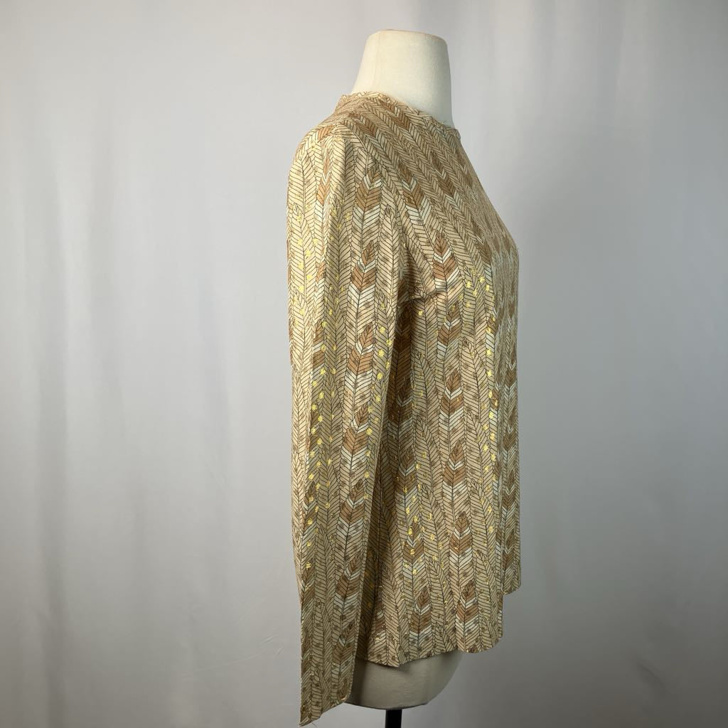 Mannequin wearing a patterned beige sweater against a plain background