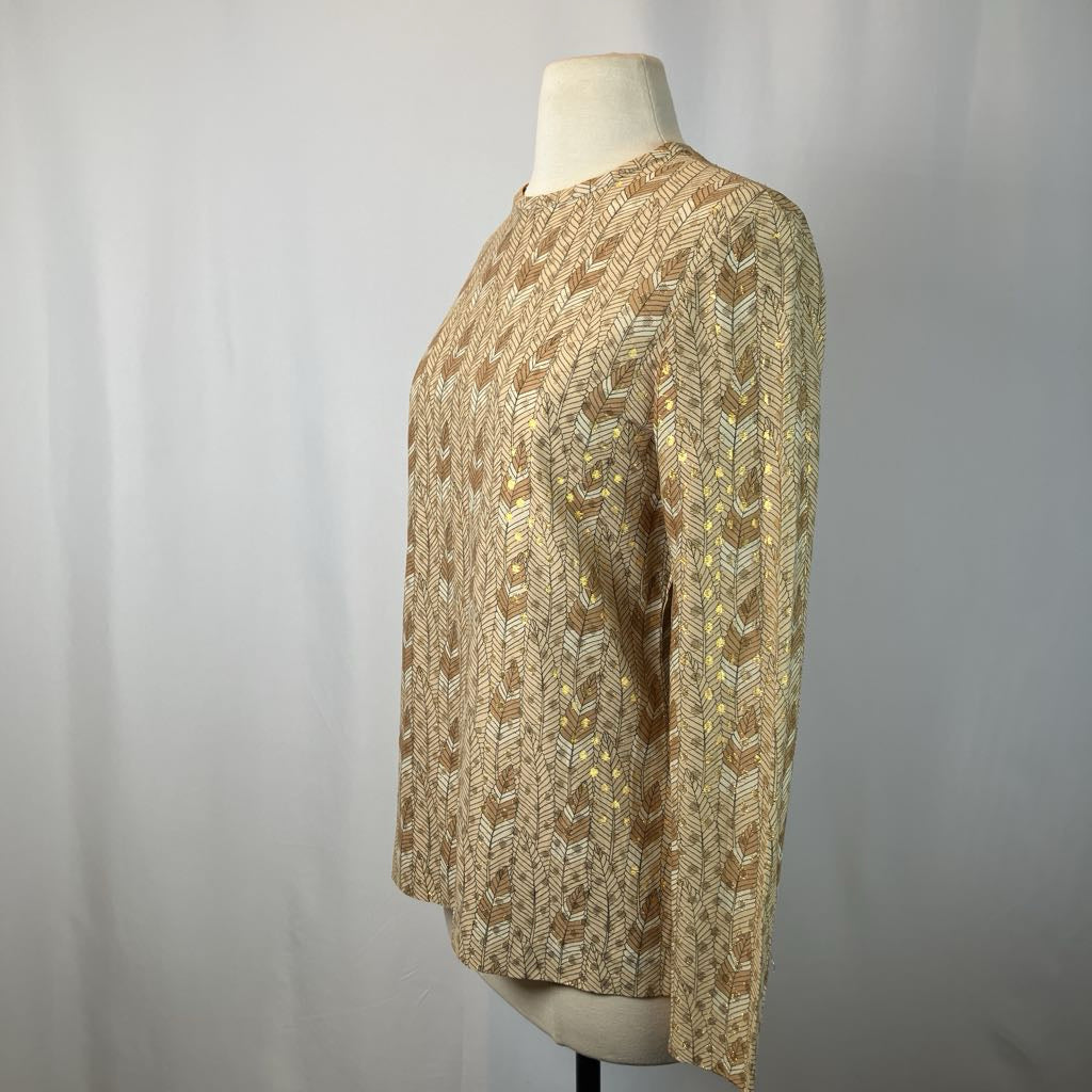 Mannequin wearing a patterned beige sweater against a plain background