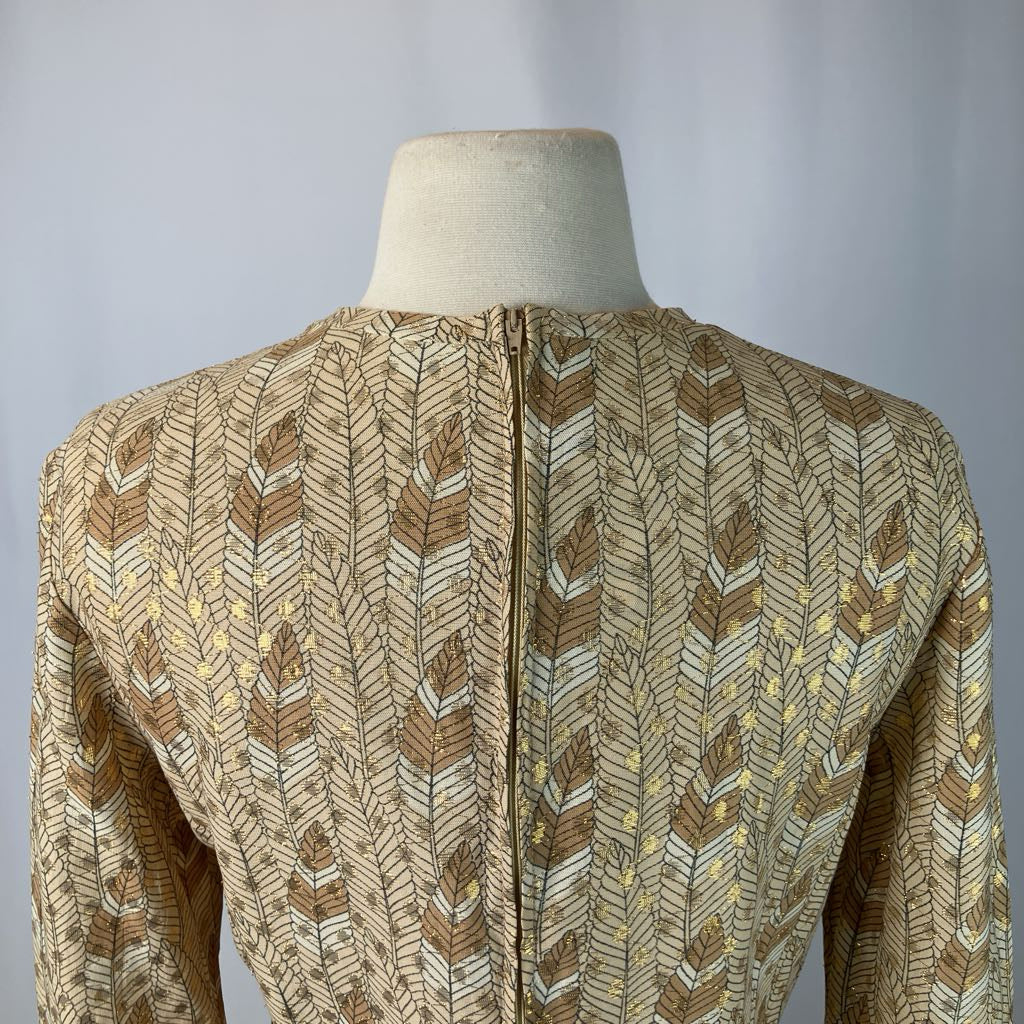 back of manequin in a gold and white patterned outfit