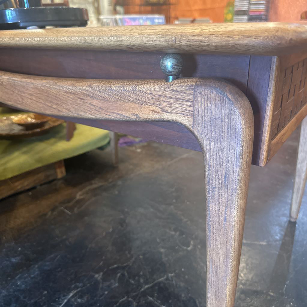 Wooden table leg on a stone floor with blurred background