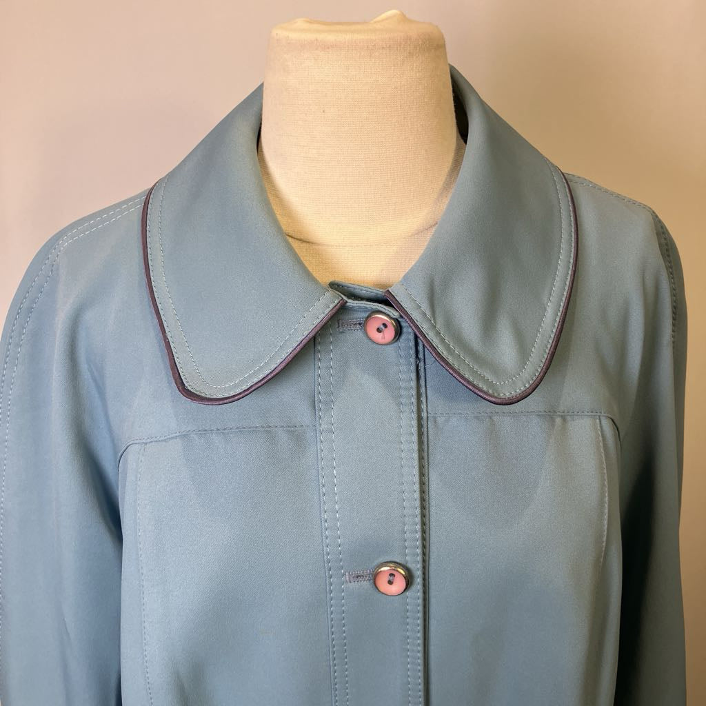 Light blue jacket with a collar on a mannequin against a beige background