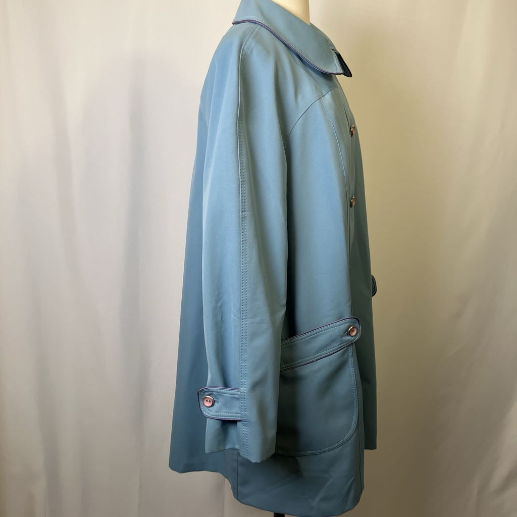 Blue jacket on a mannequin against a plain background