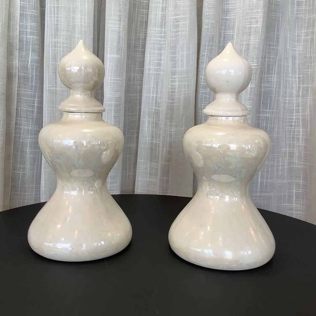 Two ceramic canisters against neutral background 